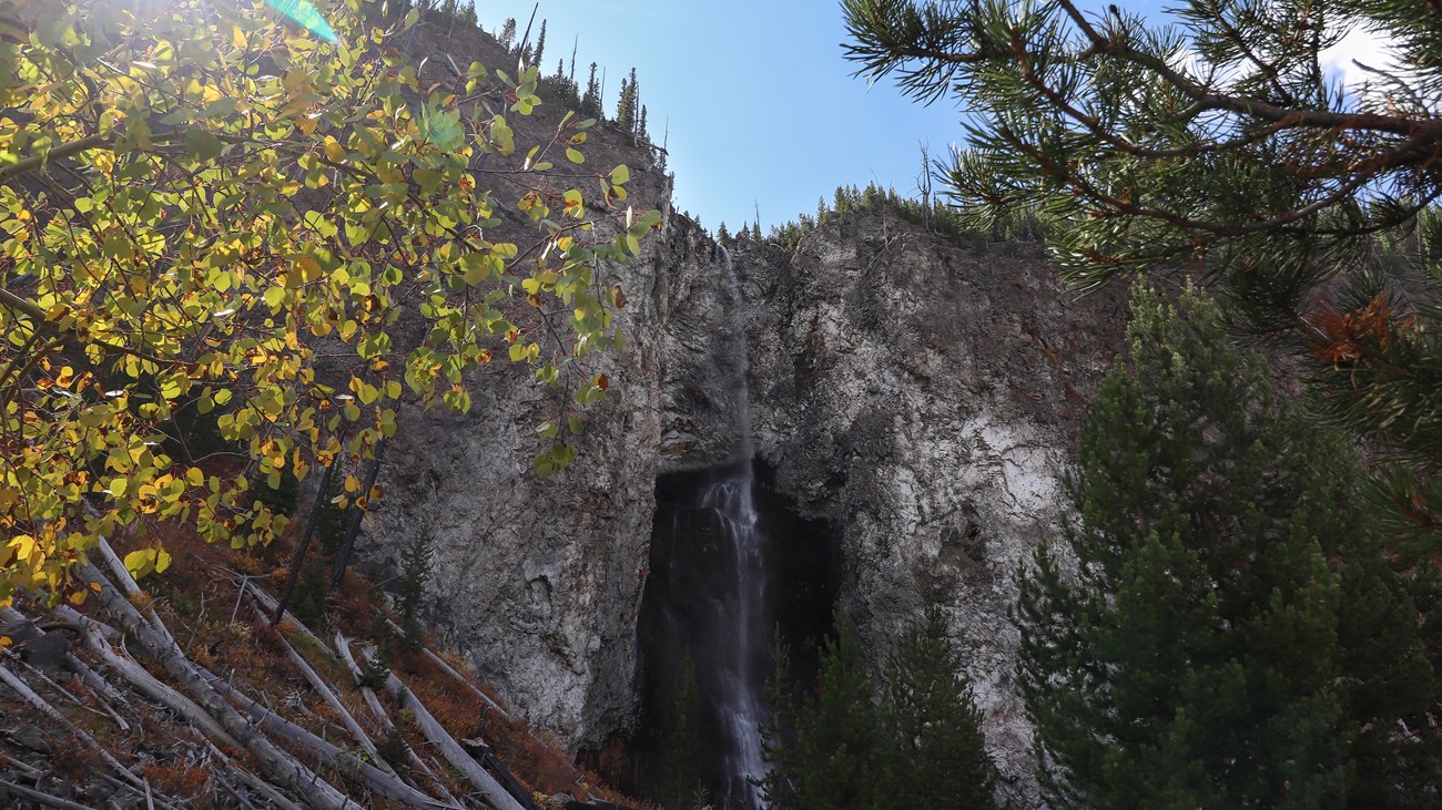 Fairy Falls dropping from a tall rocky Yellowstone cliff